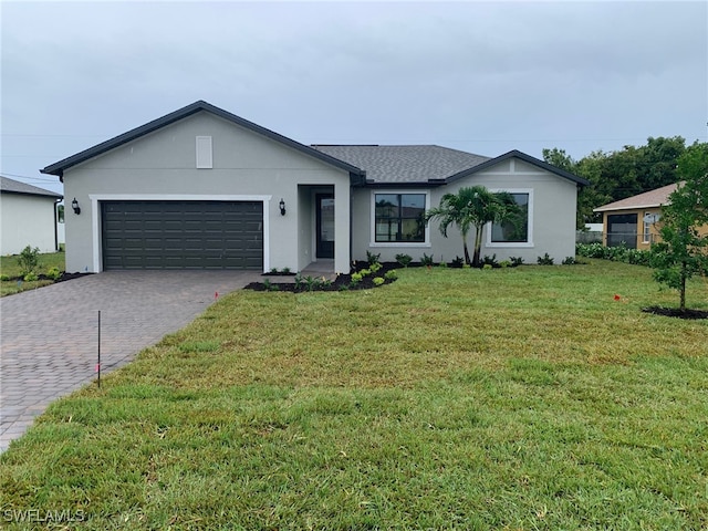 ranch-style house featuring a garage and a front lawn