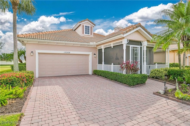 mediterranean / spanish home with covered porch and a garage