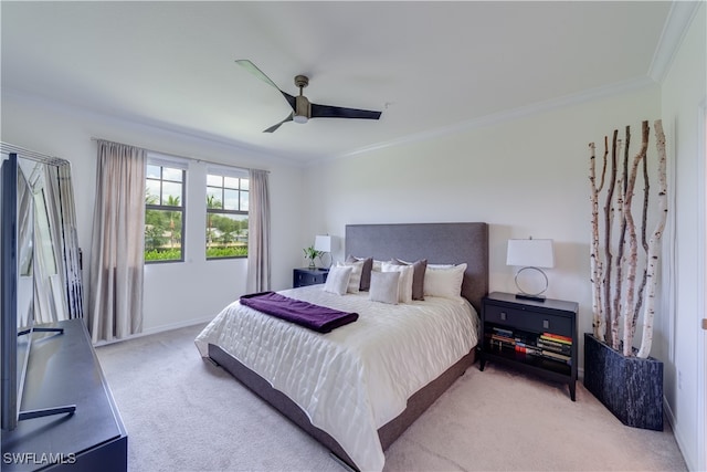 carpeted bedroom featuring crown molding and ceiling fan