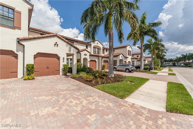 mediterranean / spanish home featuring a garage