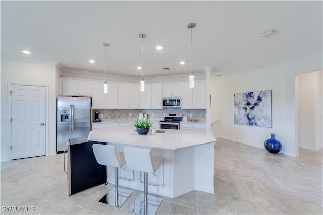 kitchen featuring a kitchen island with sink, white cabinets, hanging light fixtures, and stainless steel appliances