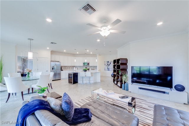 living room featuring ornamental molding and ceiling fan