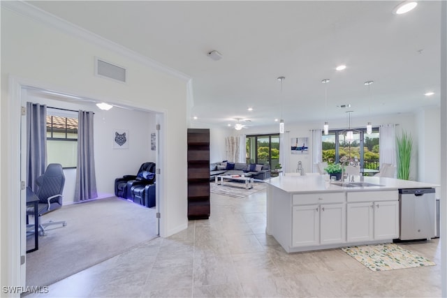 kitchen with dishwasher, an island with sink, sink, hanging light fixtures, and white cabinetry