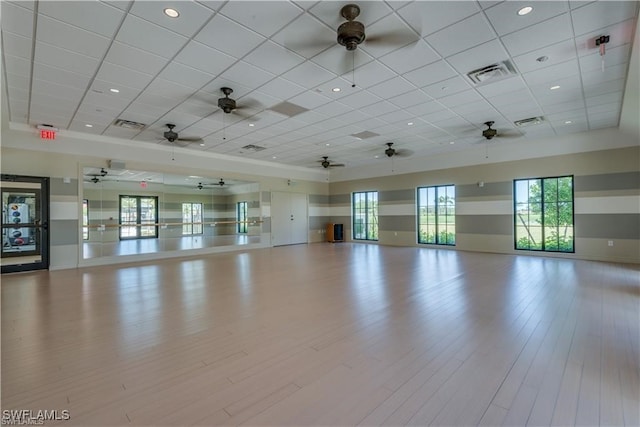 unfurnished room featuring light hardwood / wood-style flooring and a drop ceiling