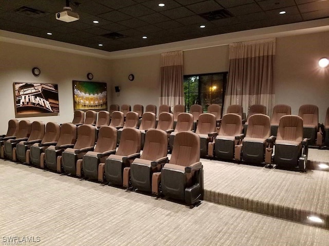 home theater room featuring carpet and a paneled ceiling