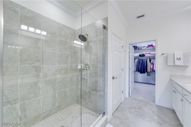 bathroom featuring vanity, crown molding, and a shower with door