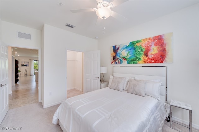 bedroom featuring light carpet and ceiling fan