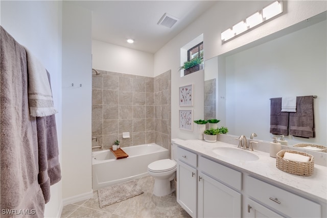 full bathroom with tiled shower / bath, vanity, toilet, and tile patterned floors