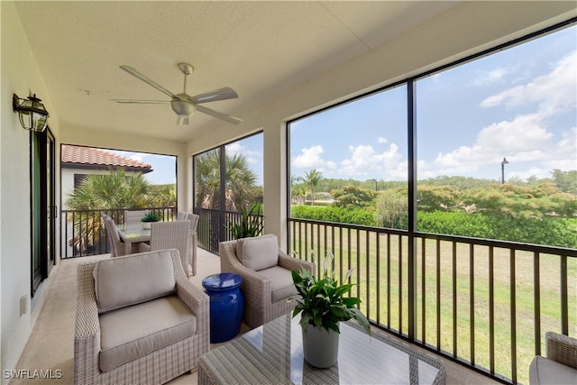 sunroom / solarium featuring ceiling fan