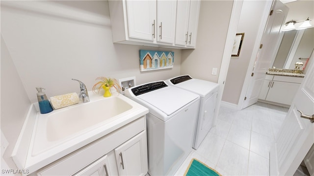 laundry area featuring cabinets, sink, light tile patterned flooring, and washer and dryer