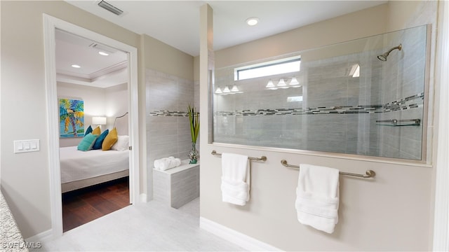 bathroom featuring a tile shower and wood-type flooring