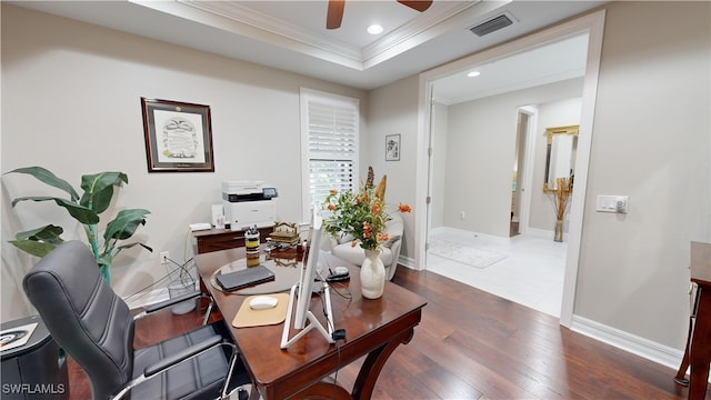 home office featuring a tray ceiling, ceiling fan, dark hardwood / wood-style flooring, and crown molding