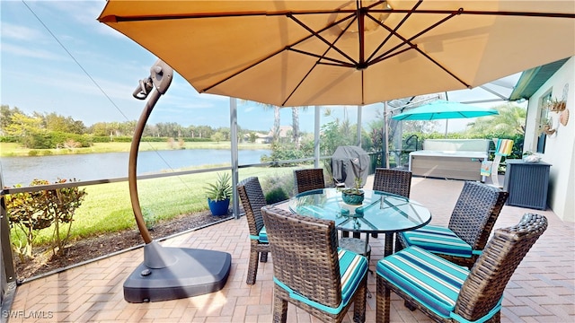 view of patio featuring a hot tub, a water view, and area for grilling