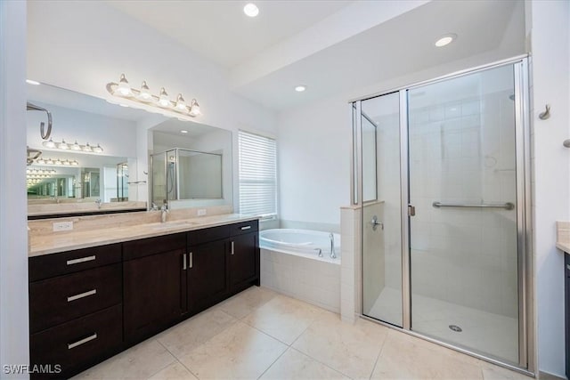 bathroom with plus walk in shower, tile patterned flooring, and vanity