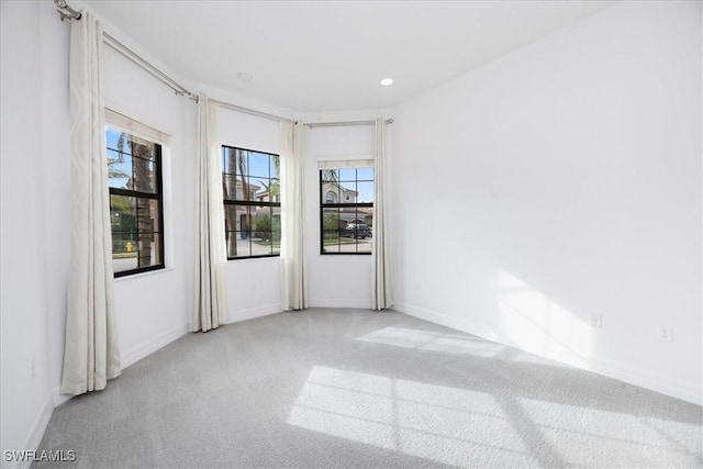 carpeted spare room with a wealth of natural light