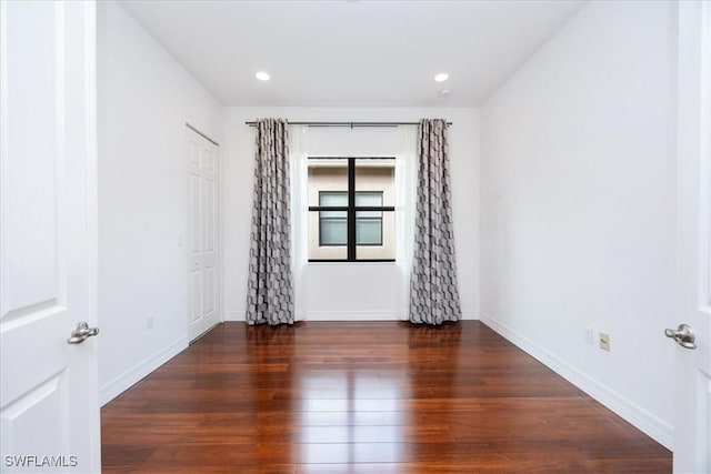 spare room with dark hardwood / wood-style flooring