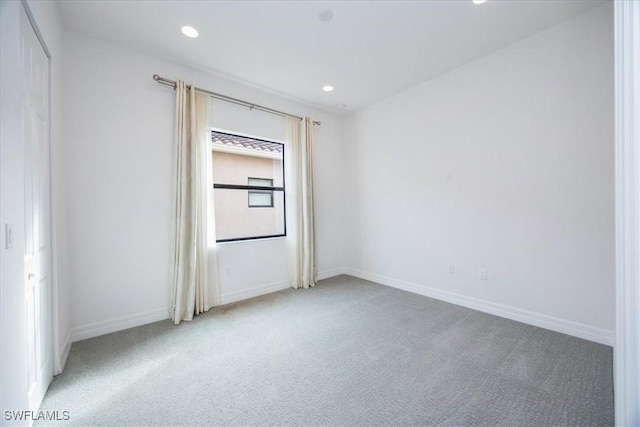 empty room featuring light colored carpet