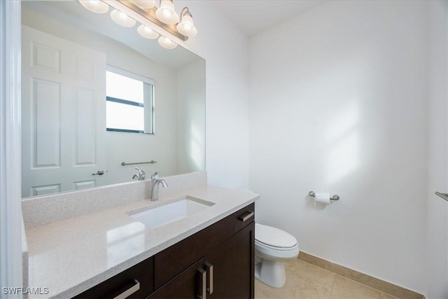 bathroom featuring tile patterned floors, vanity, and toilet