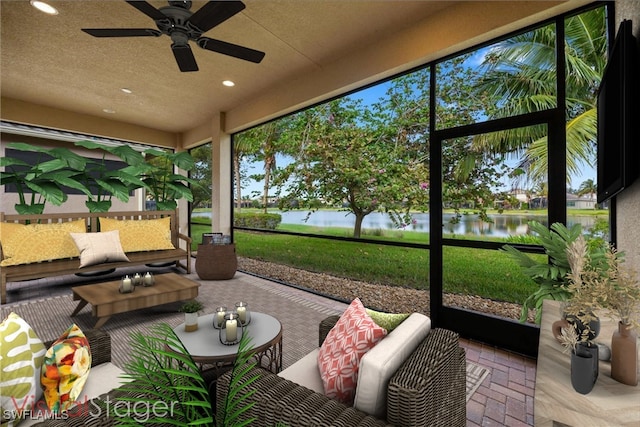 sunroom featuring ceiling fan