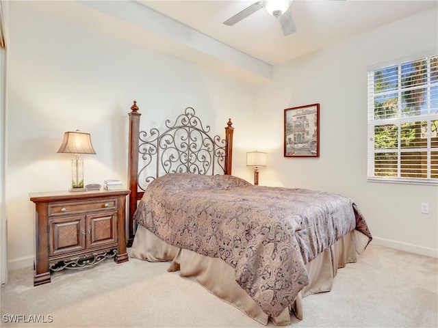 bedroom featuring light colored carpet and ceiling fan