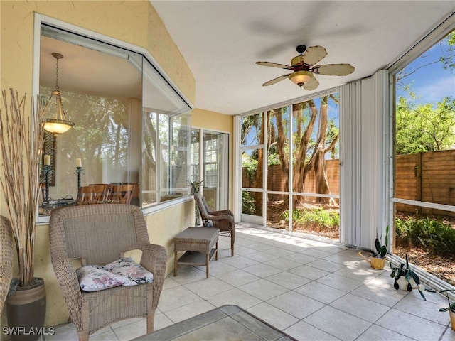 sunroom with ceiling fan and a healthy amount of sunlight