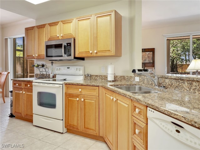 kitchen featuring white appliances, ornamental molding, sink, and a wealth of natural light