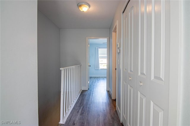 corridor with dark hardwood / wood-style flooring