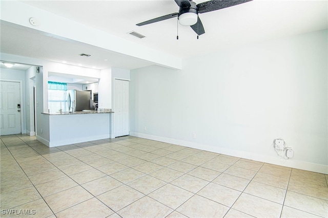 unfurnished living room with ceiling fan and light tile patterned floors