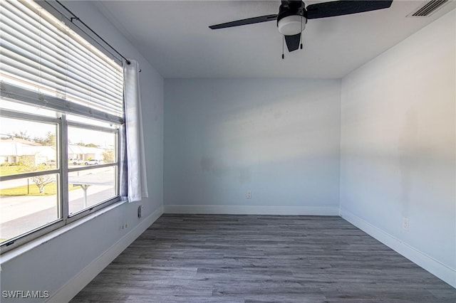 unfurnished room featuring ceiling fan and dark wood-type flooring