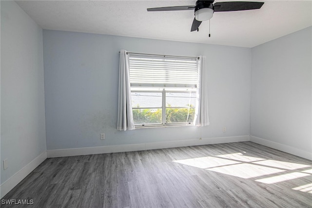 spare room featuring ceiling fan, hardwood / wood-style floors, and a textured ceiling