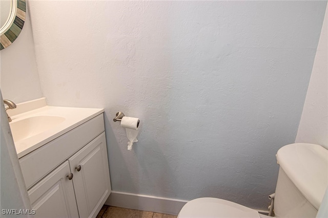 bathroom with toilet and vanity