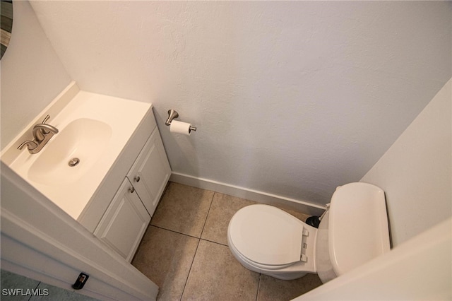 bathroom featuring vanity, toilet, and tile patterned floors