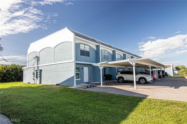 view of front of house featuring a front yard and a carport