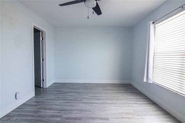 spare room featuring hardwood / wood-style floors and ceiling fan