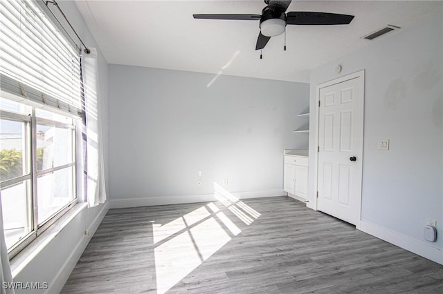 empty room featuring ceiling fan and wood-type flooring