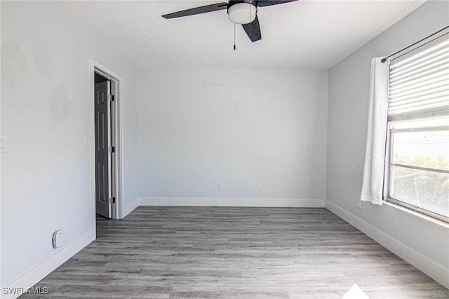 unfurnished room with ceiling fan and hardwood / wood-style flooring