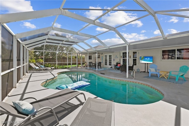 view of swimming pool with a patio and a lanai