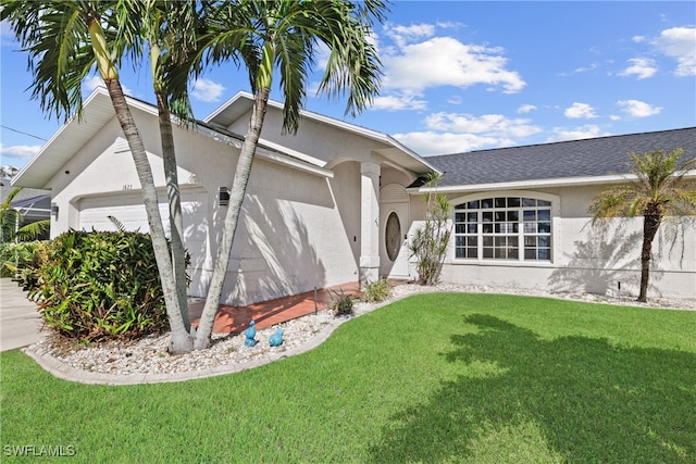 ranch-style home with a garage and a front lawn