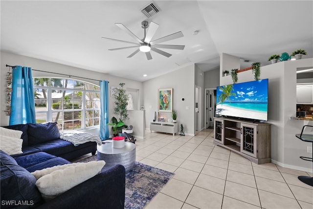 living room featuring ceiling fan, light tile patterned flooring, and vaulted ceiling