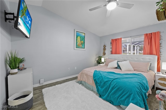 bedroom featuring lofted ceiling, dark wood-type flooring, and ceiling fan