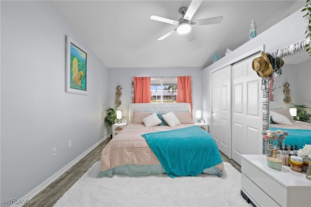 bedroom with a closet, hardwood / wood-style flooring, vaulted ceiling, and ceiling fan