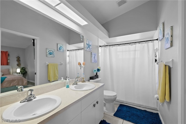 full bathroom featuring vanity, toilet, tile patterned floors, and shower / tub combo with curtain