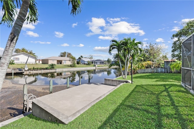 exterior space with a yard, a water view, and glass enclosure