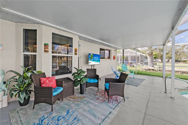 view of patio featuring glass enclosure