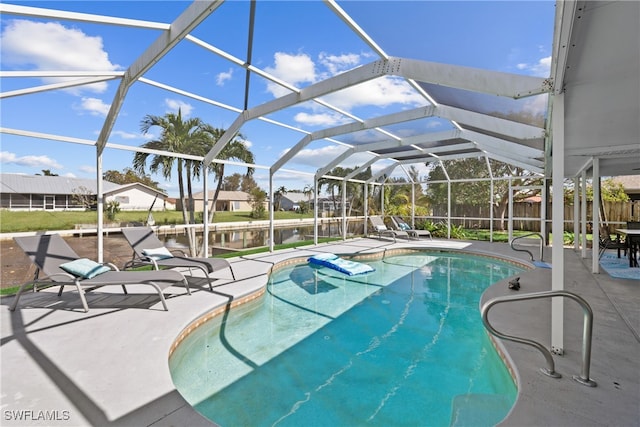 view of swimming pool featuring a patio area and a lanai