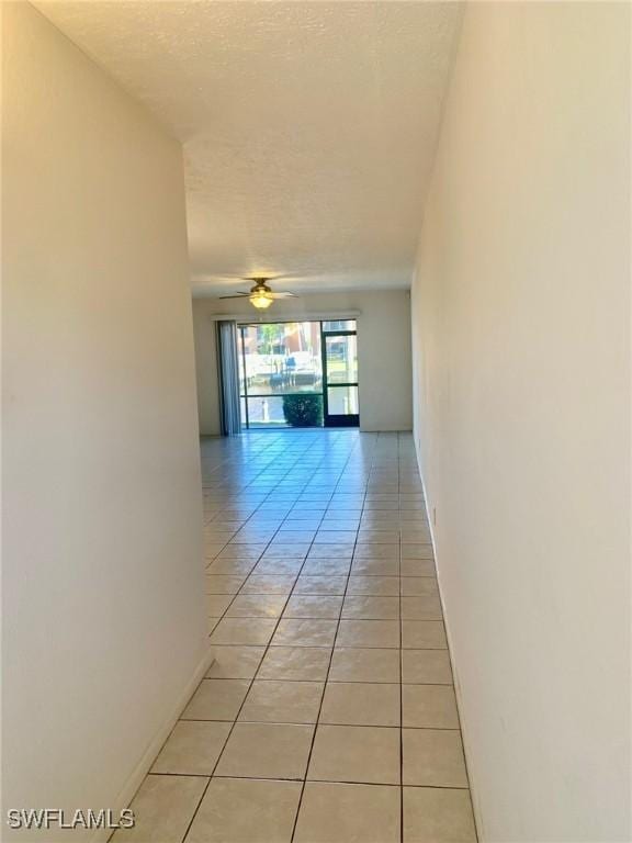 corridor featuring light tile patterned floors