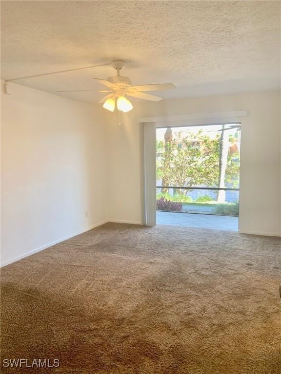 carpeted spare room with ceiling fan and a textured ceiling