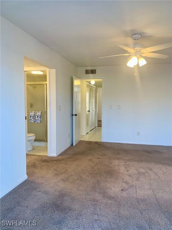 empty room with light colored carpet and ceiling fan