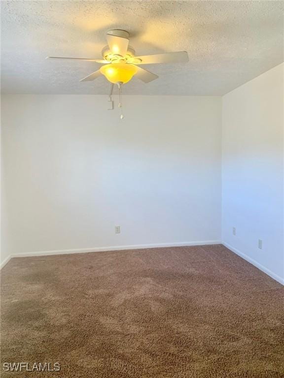 carpeted spare room featuring ceiling fan and a textured ceiling