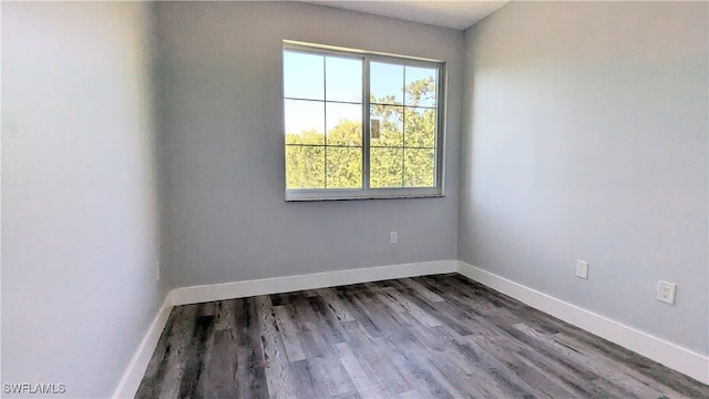 empty room with dark wood-type flooring